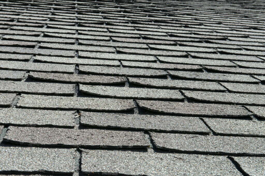 Curled and damaged roof shingles