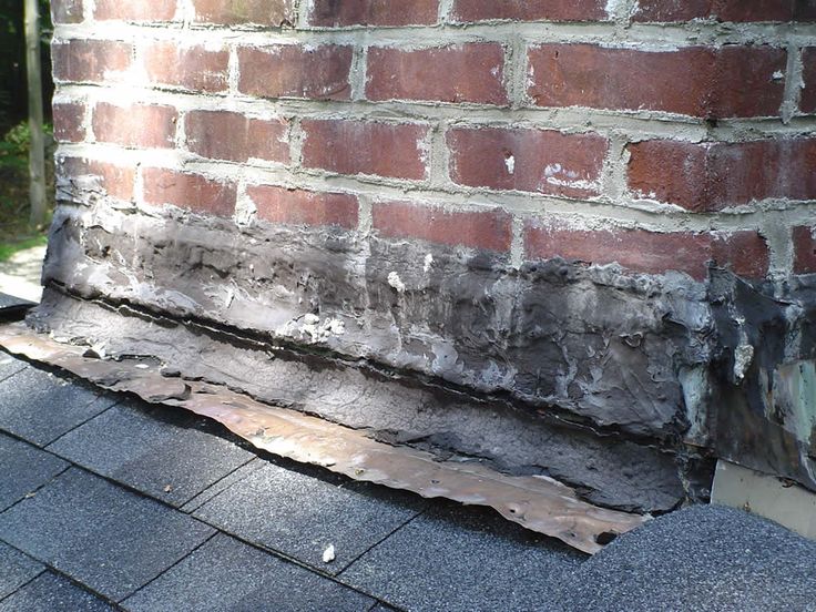 Damaged roof flashing around chimney